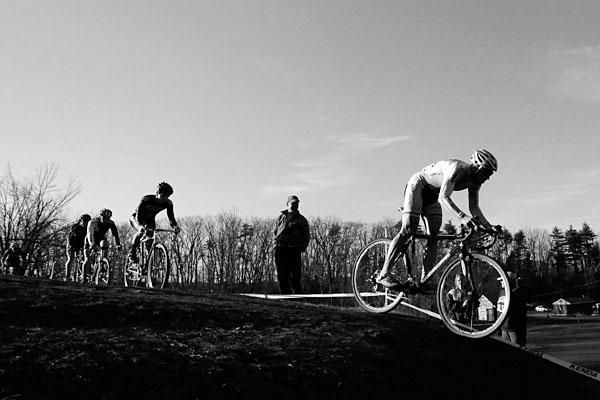 The elite men traverse a ridge in the waning hours of daylight.