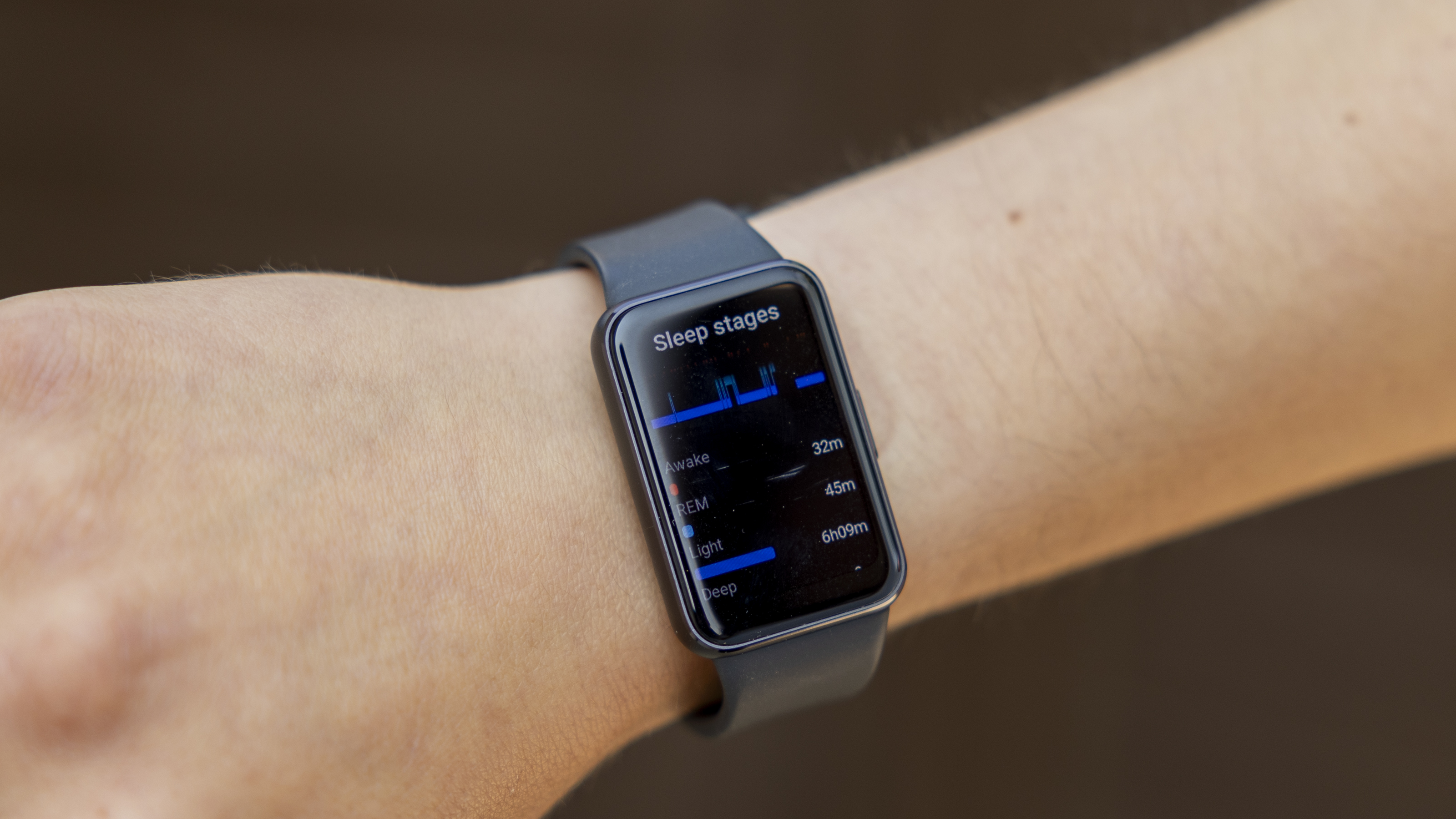 The Samsung Galaxy Fit 3 watch in grey worn on a female wrist
