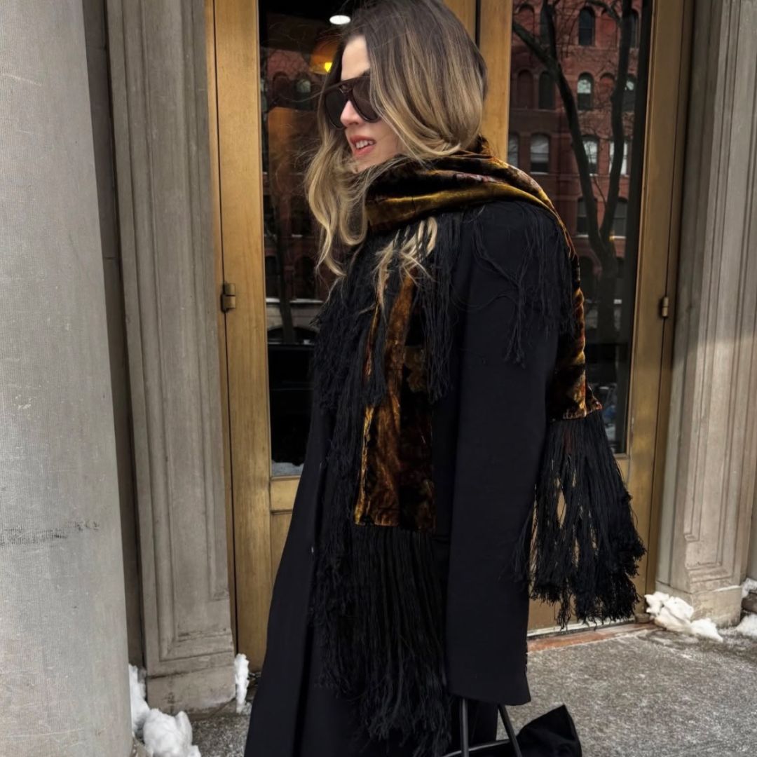 Christina Grasso wearing a printed velvet scarf with a black evening coat