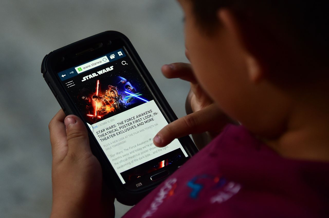 Child playing with phone. 