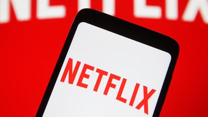 In this photo illustration the Netflix logo seen displayed on a mobile phone and on a pc screen.