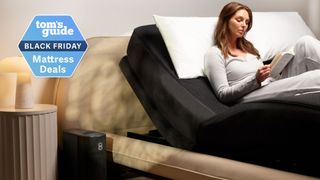 A woman sitting in adjustable bed covered by Eight Sleep Pod 4 Ultra with book in hand