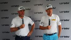 Lee Westwood and Ian Poulter speak to media holding microphones