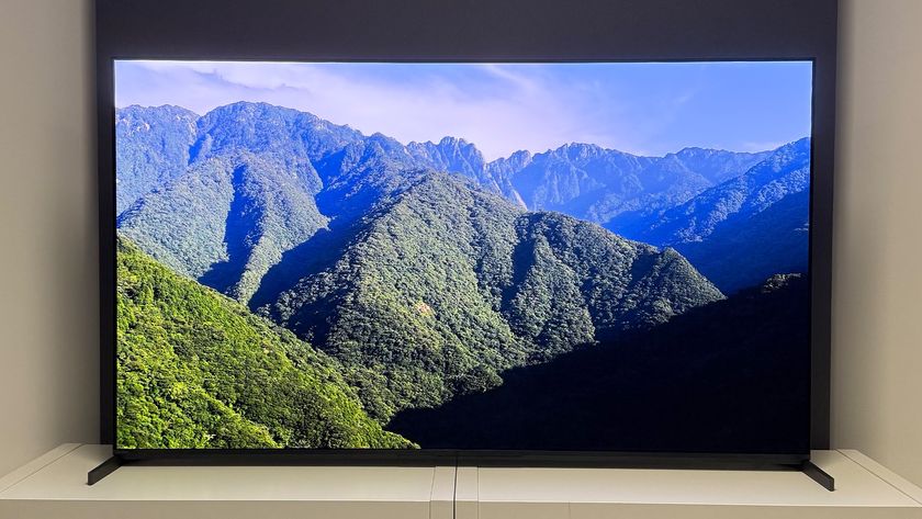 The 55-inch Sony Bravia 8 II QD-OLED TV photographed on a white table. On the screen is a nature documentary.