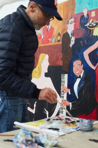 Artist painting as someone playing piano