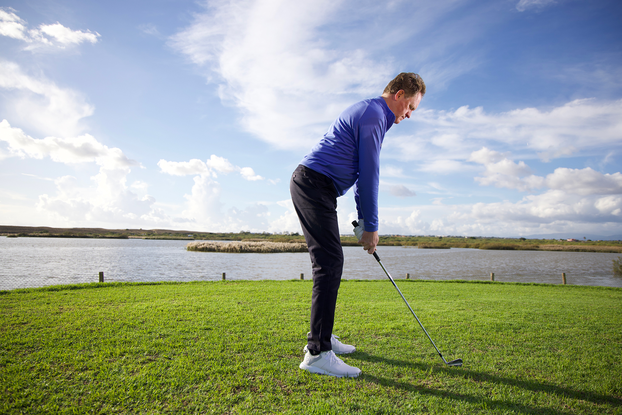 Keith Wood demonstrating the correct posture for the golf swing, with arms hanging naturally, room between the legs and hands and the back and hips nicely tilted to create an athletic position
