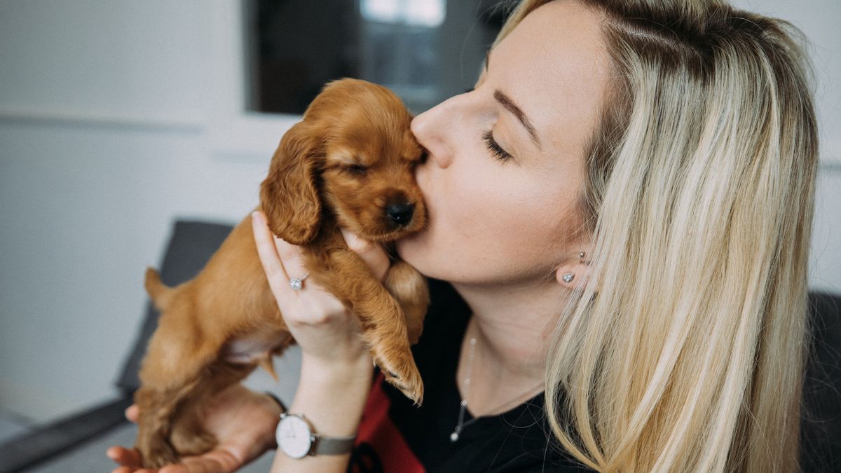 lady cuddling new puppy