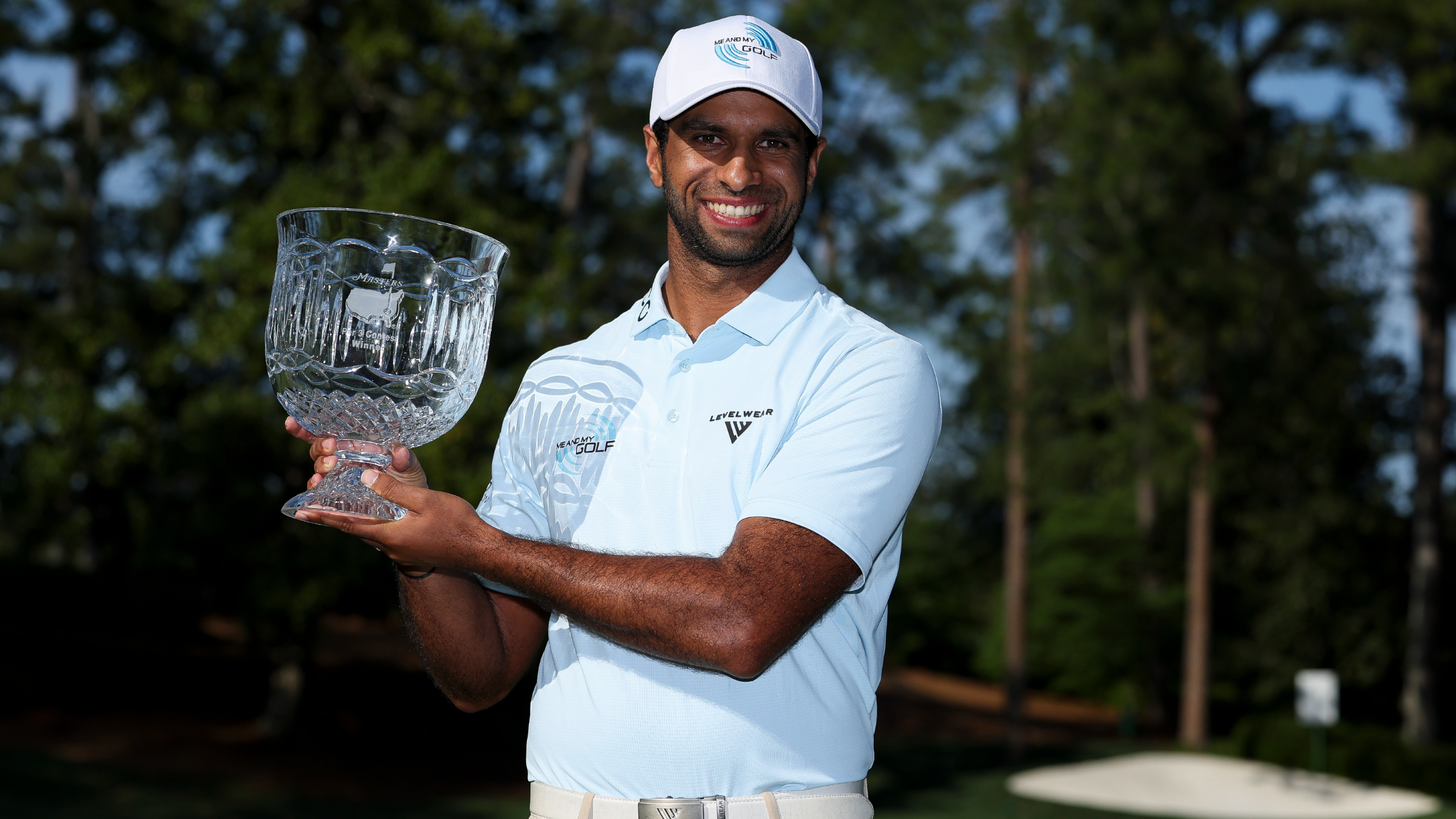 Aaron Rai with the Par 3 Contest trophy
