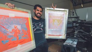A photograph of MARIO MORENO holding his screenprinted pictures