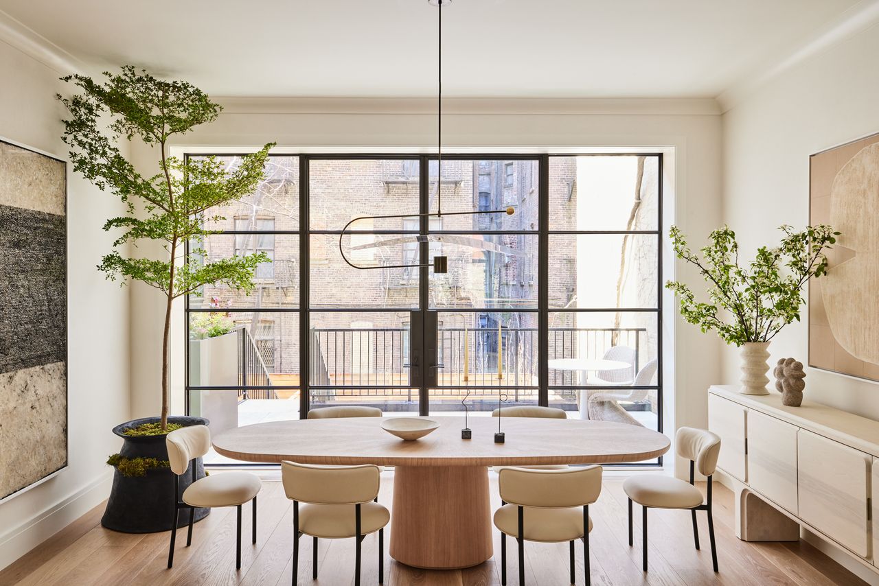 beige minimalist dining room with oval table and white chairs