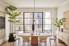 beige minimalist dining room with oval table and white chairs