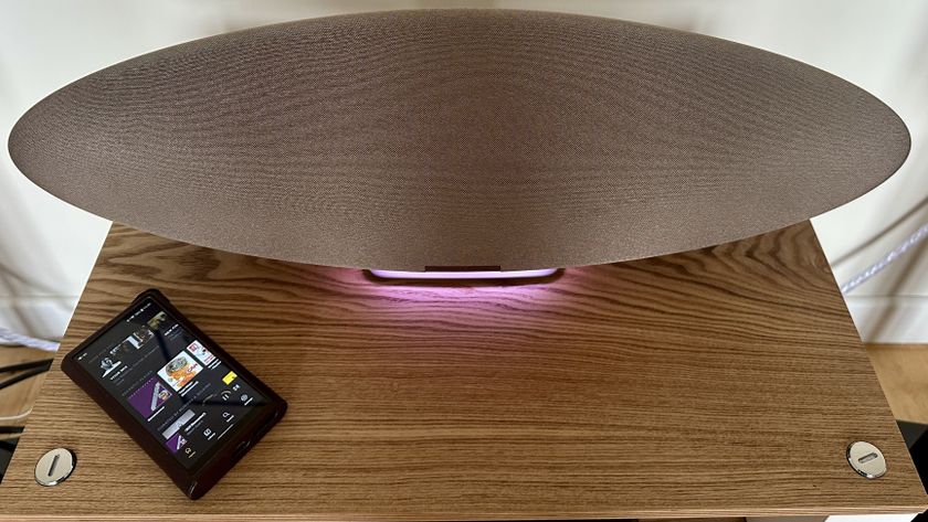 The Bowers &amp; Wilkins Zeppelin Pro Edition on a shelf with a pink light on next to a music player.