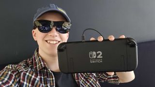 Hamish wearing Xreal glasses holding the Nintendo Switch 2