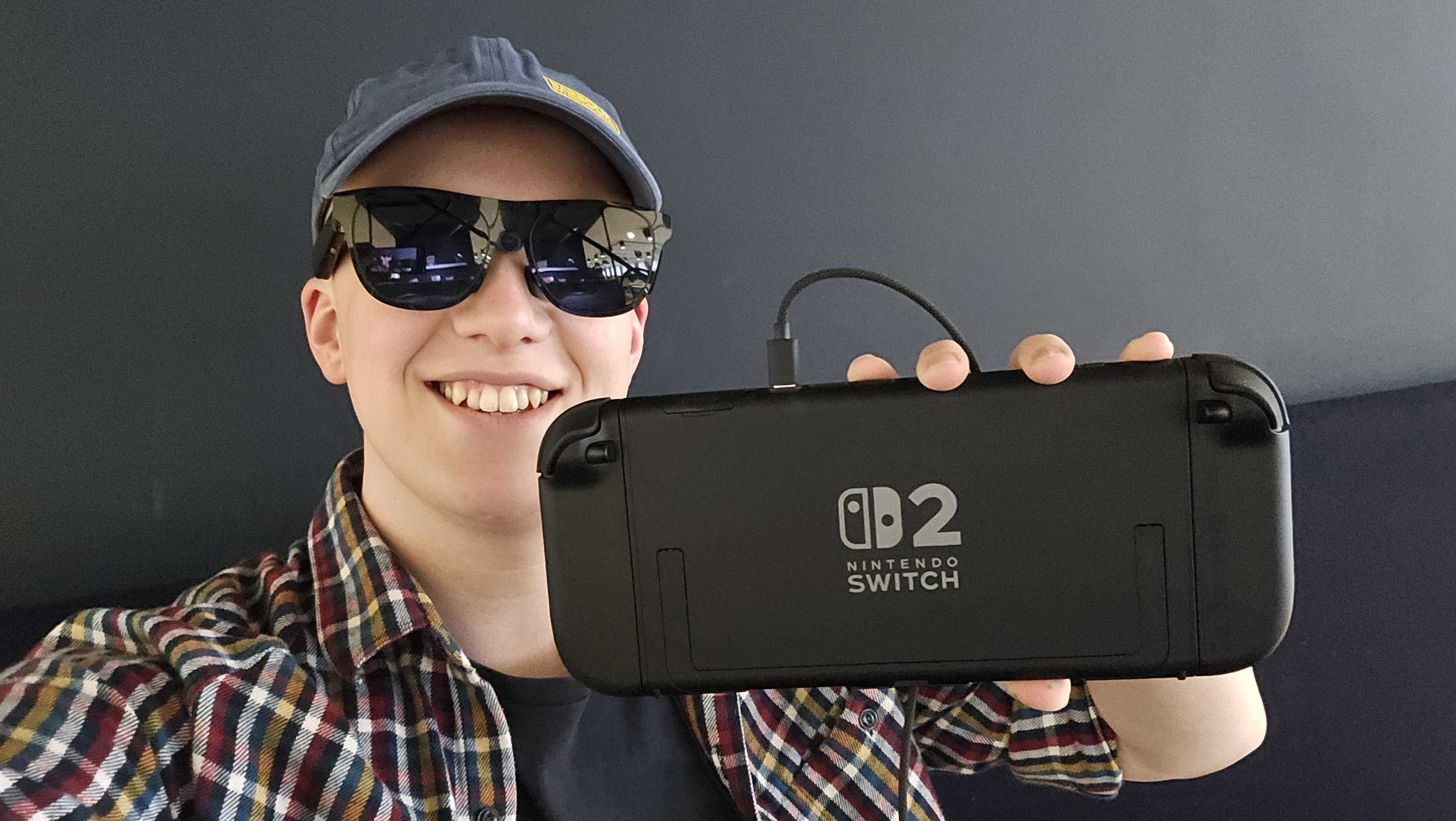 Hamish wearing Xreal glasses holding the Nintendo Switch 2