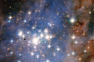This NASA/ESA Hubble Space Telescope image features the star cluster Trumpler 14. One of the largest gatherings of hot, massive and bright stars in the Milky Way, this cluster houses some of the most luminous stars in our entire galaxy.