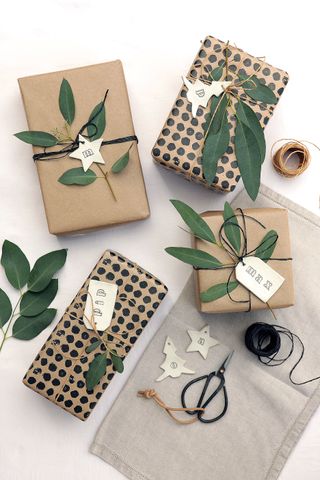 Gifts in brown paper with foliage and handmade tags