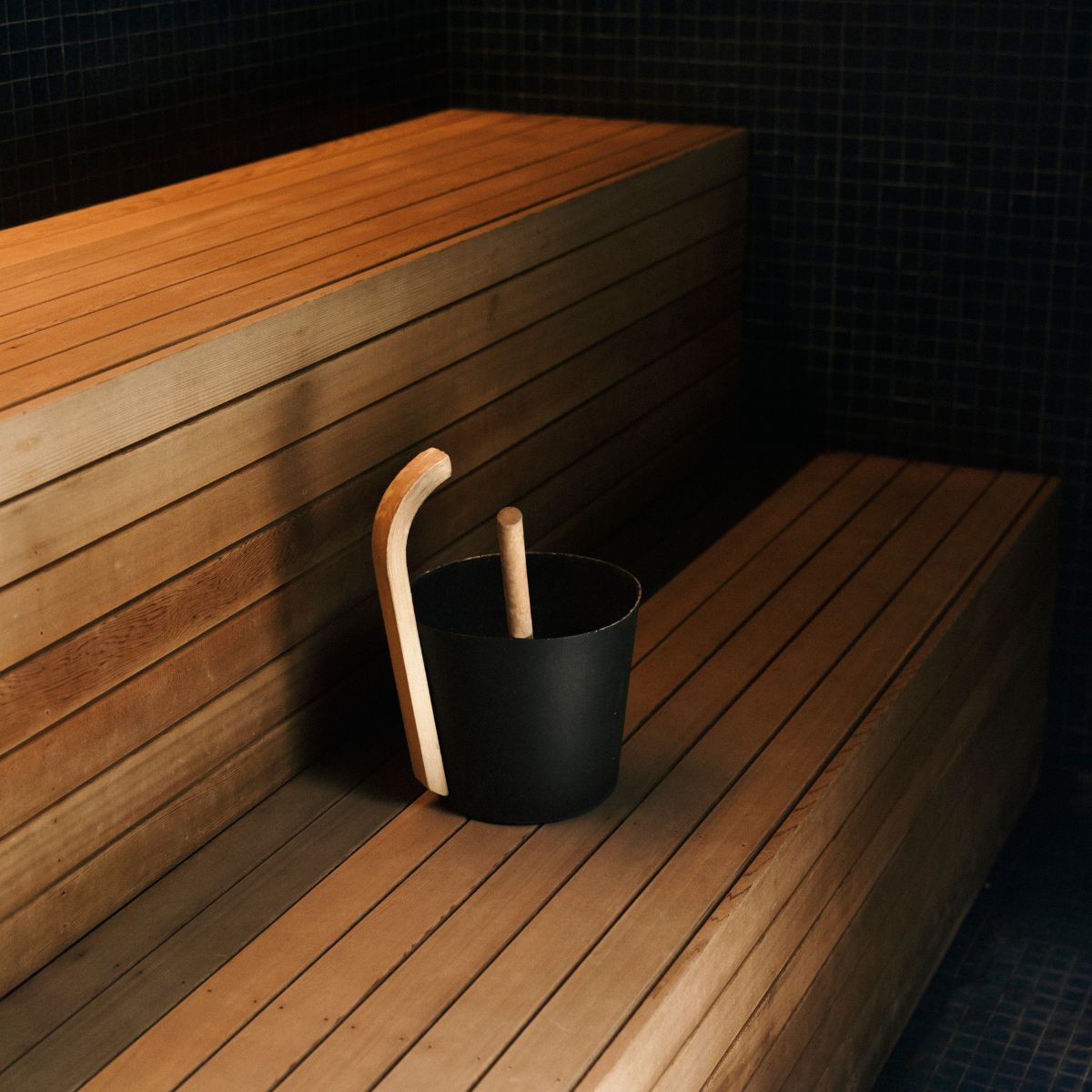 A close up shot of a sauna, with steam bucket and ladel