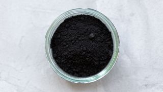Pot of activated charcoal powder, used to whiten teeth naturally
