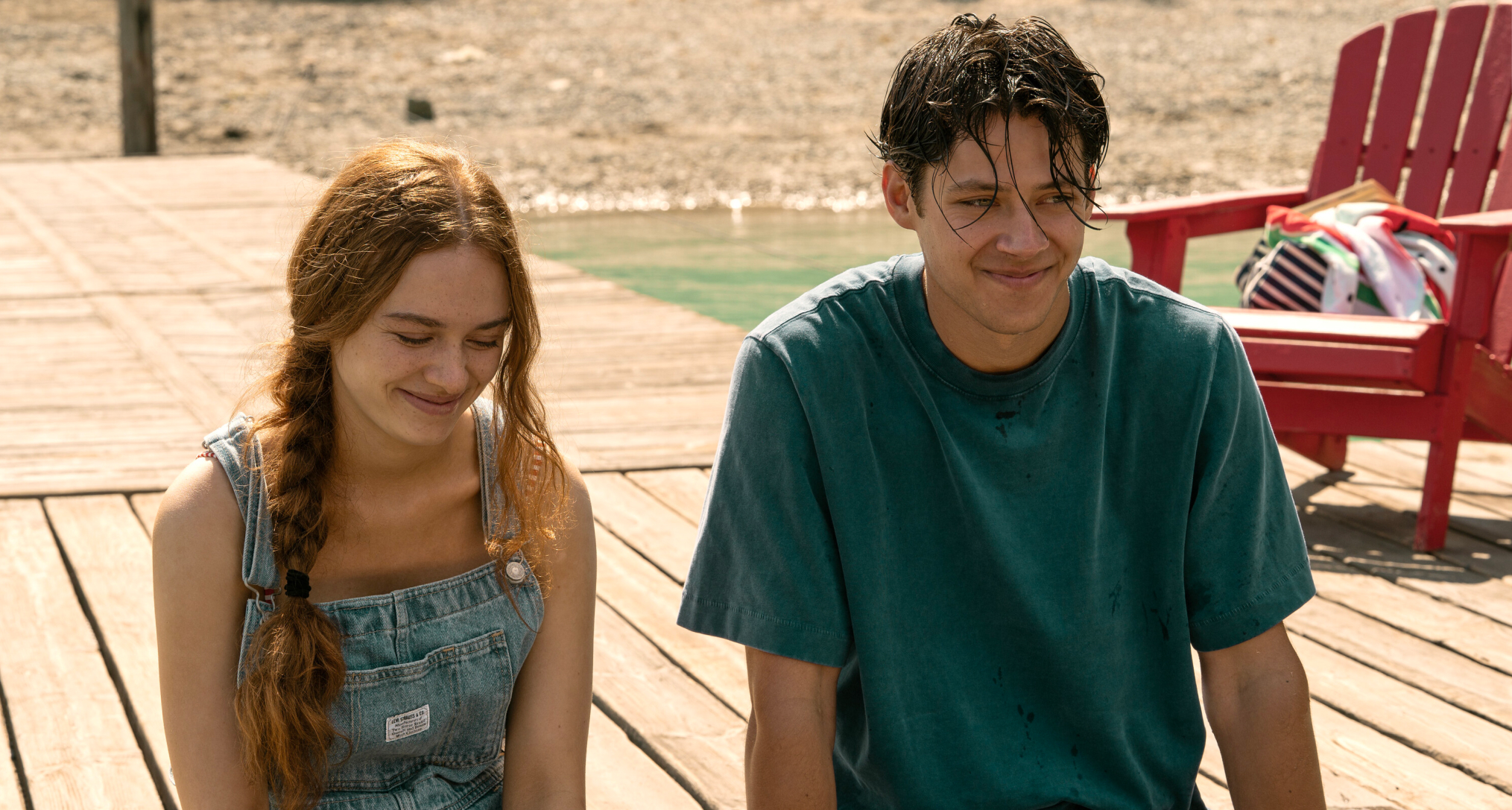 sadie soverall as percy and Matt Cornett as sam smiling and sitting on a dock together in every year after