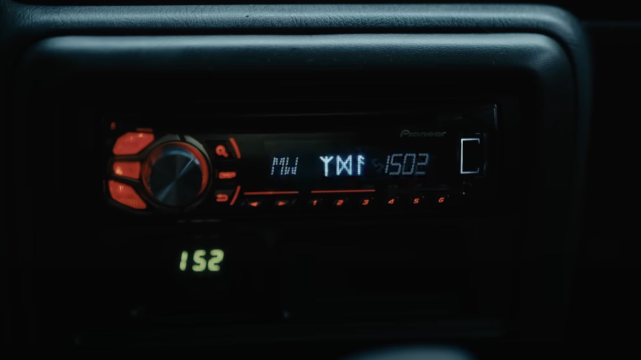 Mina's car radio malfunctioning and depicting runes in The Watchers