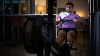 young man using one of the best rowing machines at home