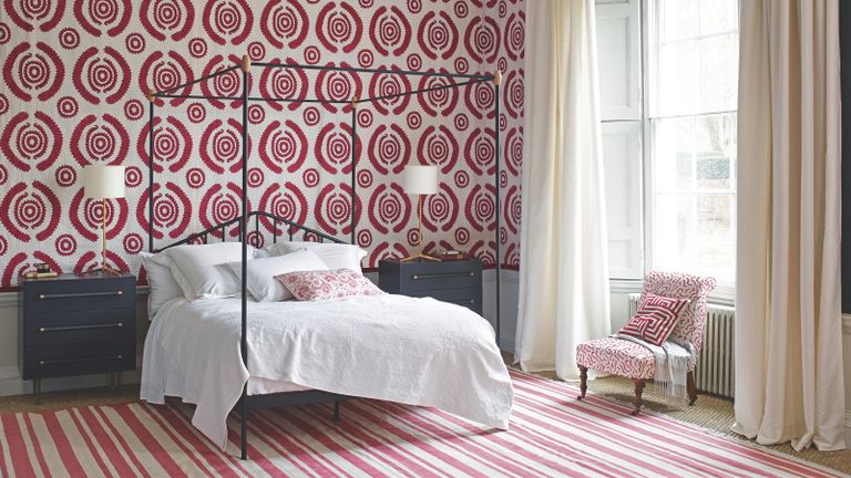 Teenage girl bedroom ideas with modern red and white target wallpaper and black four poster bed in period room