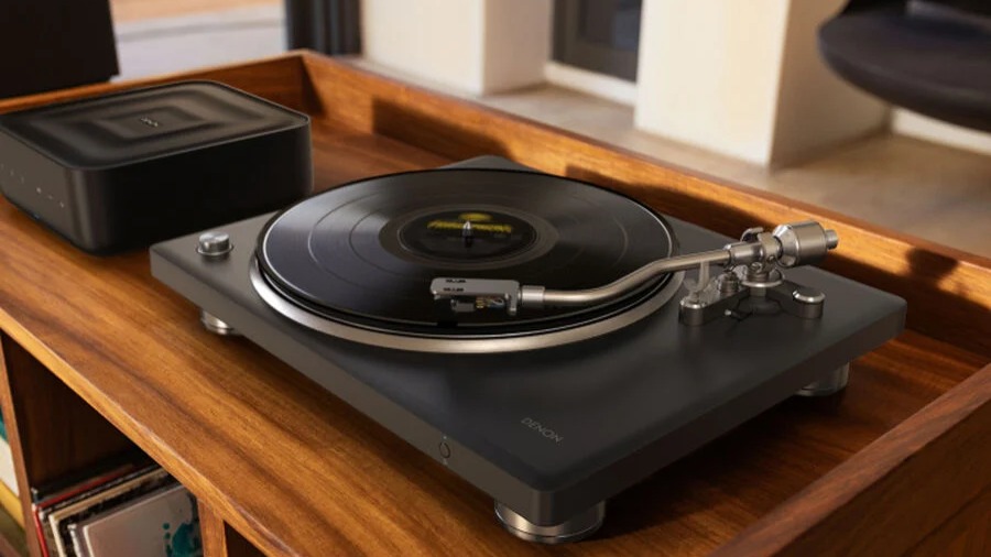 Denon DP-500BT Bluetooth turntable in black on a wooden rack
