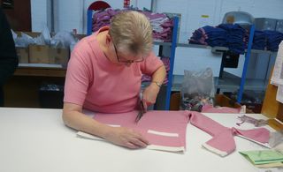 The hand-cutting of v-neck cardigans