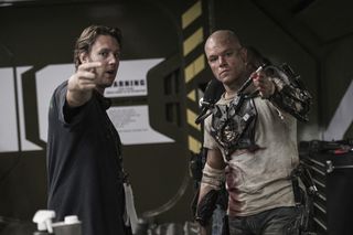Director Neill Blomkamp Points to the Distance on Set of 'Elysium'