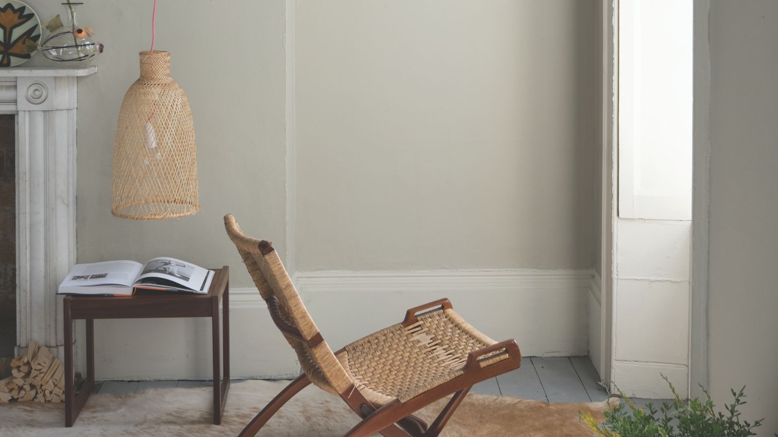 Drop Cloth painted living room with rattan lounge chair in the middle