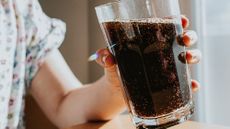 Child holding glass of soda