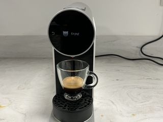 A Morning coffee maker, with a freshly-poured shot of espresso