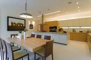 a kitchen and dining room with interesting lighting design
