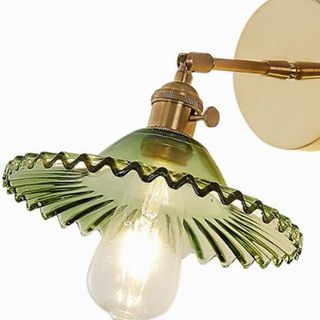 gold and green glass fluted wall light on a white background