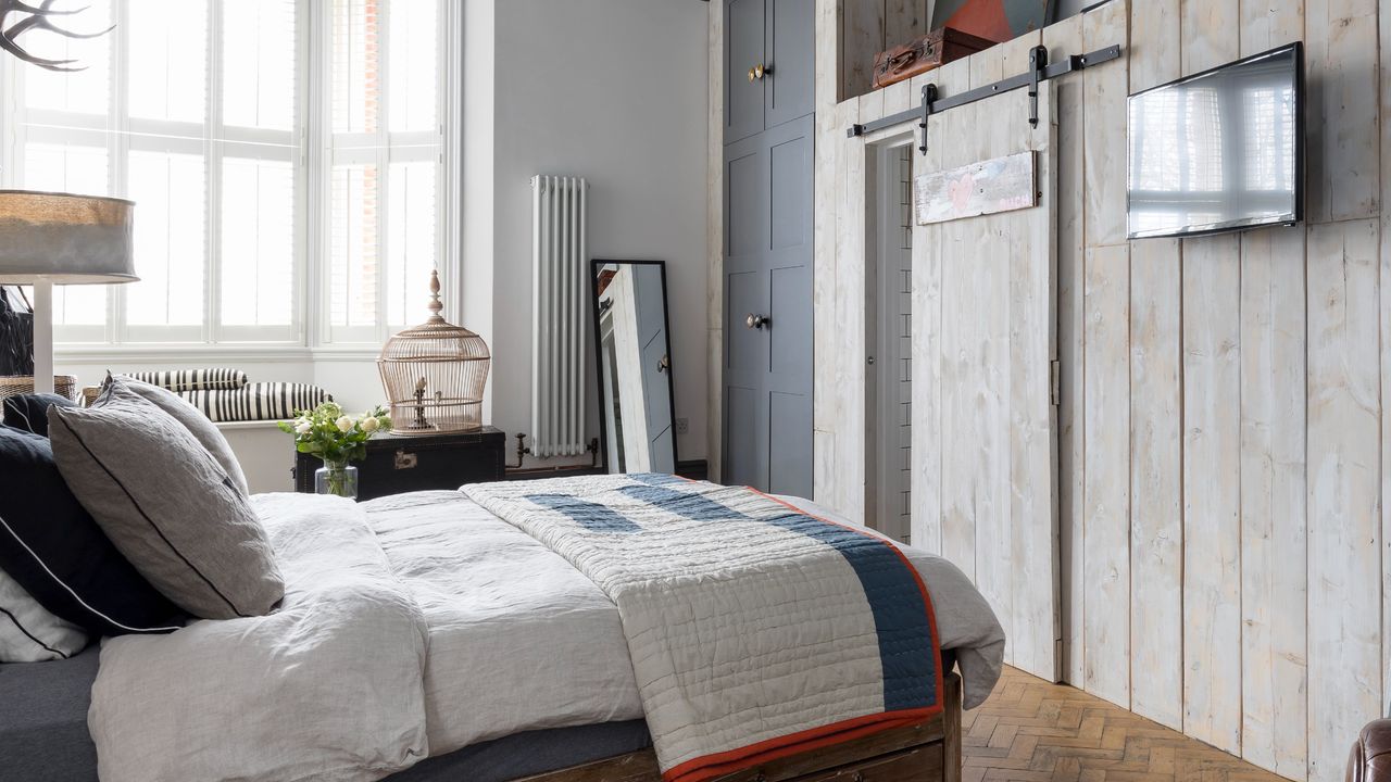 Bedroom with a sliding doors and a TV on the wall