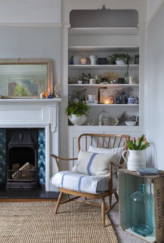 armchair with open shelves in alcove by fireplace