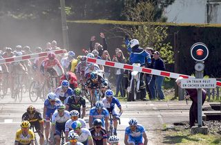 Bradley Wiggins (Team Sky) ducks under the railway crossing in the nick of time