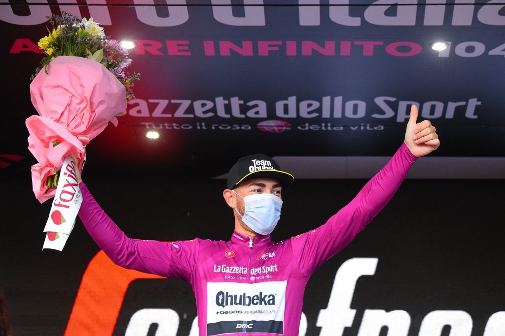 Team Qhubeka Assos rider Italys Giacomo Nizzolo celebrates his best sprinters Cyclamen jersey on the podium of the fifth stage of the Giro dItalia 2021 cycling race 177 km between Modena and Cattolica EmiliaRomagna on May 12 2021 Photo by Dario BELINGHERI AFP Photo by DARIO BELINGHERIAFP via Getty Images