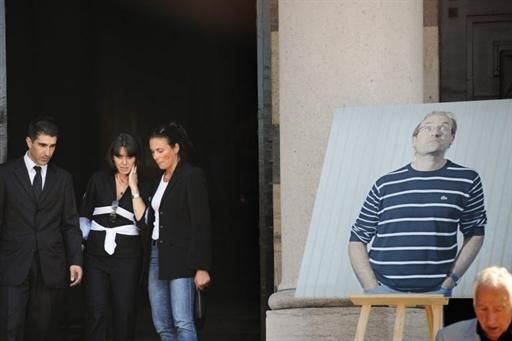 Valery Fignon (C), the wife of French cycling champion Laurent Fignon leaves the crematorium after the funeral ceremony for her husband, on September 3, 2010 at the Pere Lachaise in Paris.