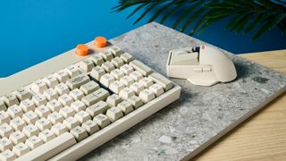 The Lofree Block keyboard on a stone surface with a blue wall in the background.