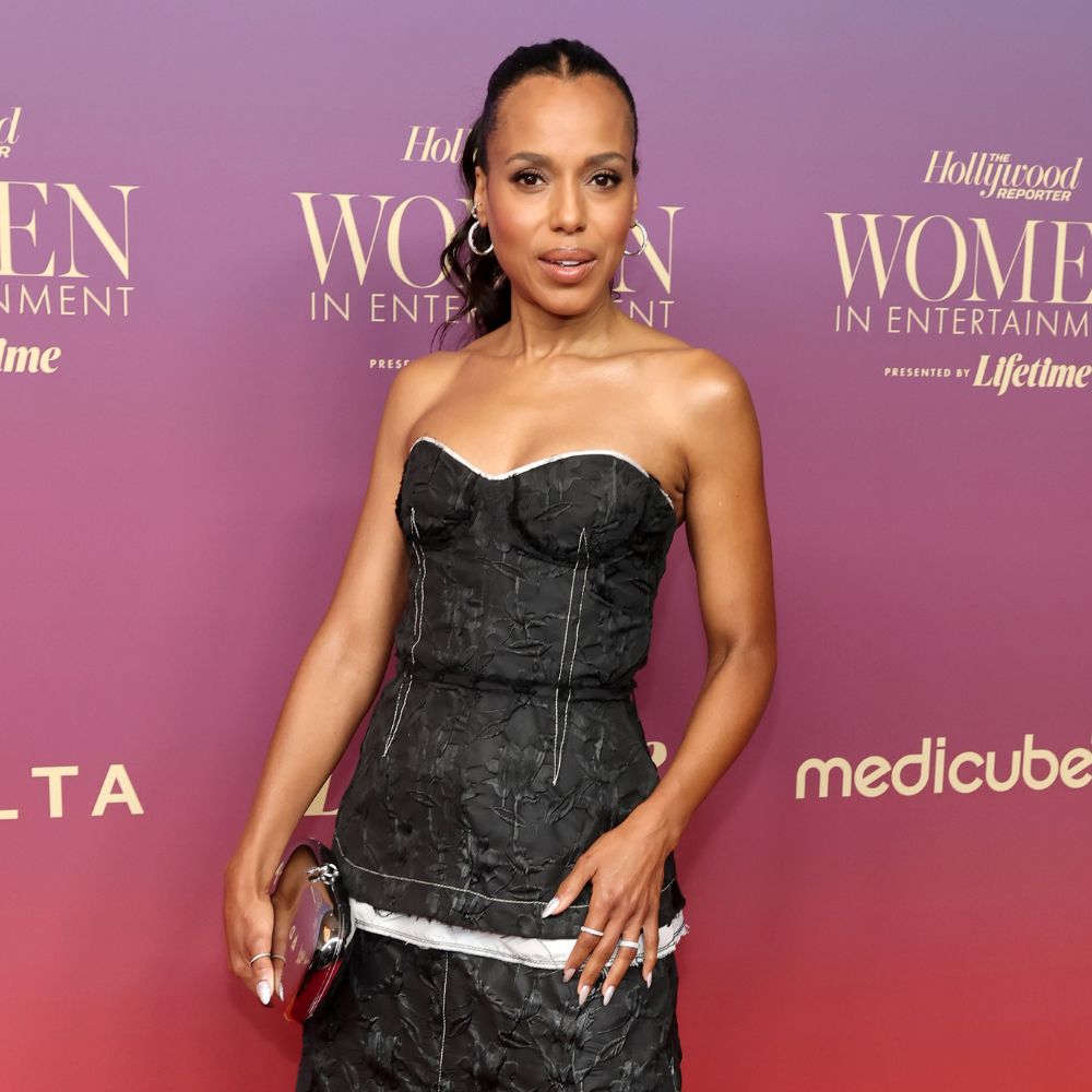 Kerry Washington poses on the red carper wearing a black two-piece skirt set with silver high heels.