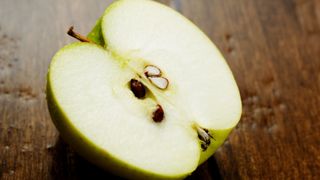 green apple cut in half showing pips