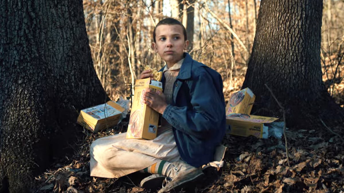 millie bobby brown as eleven eating waffles in the woods