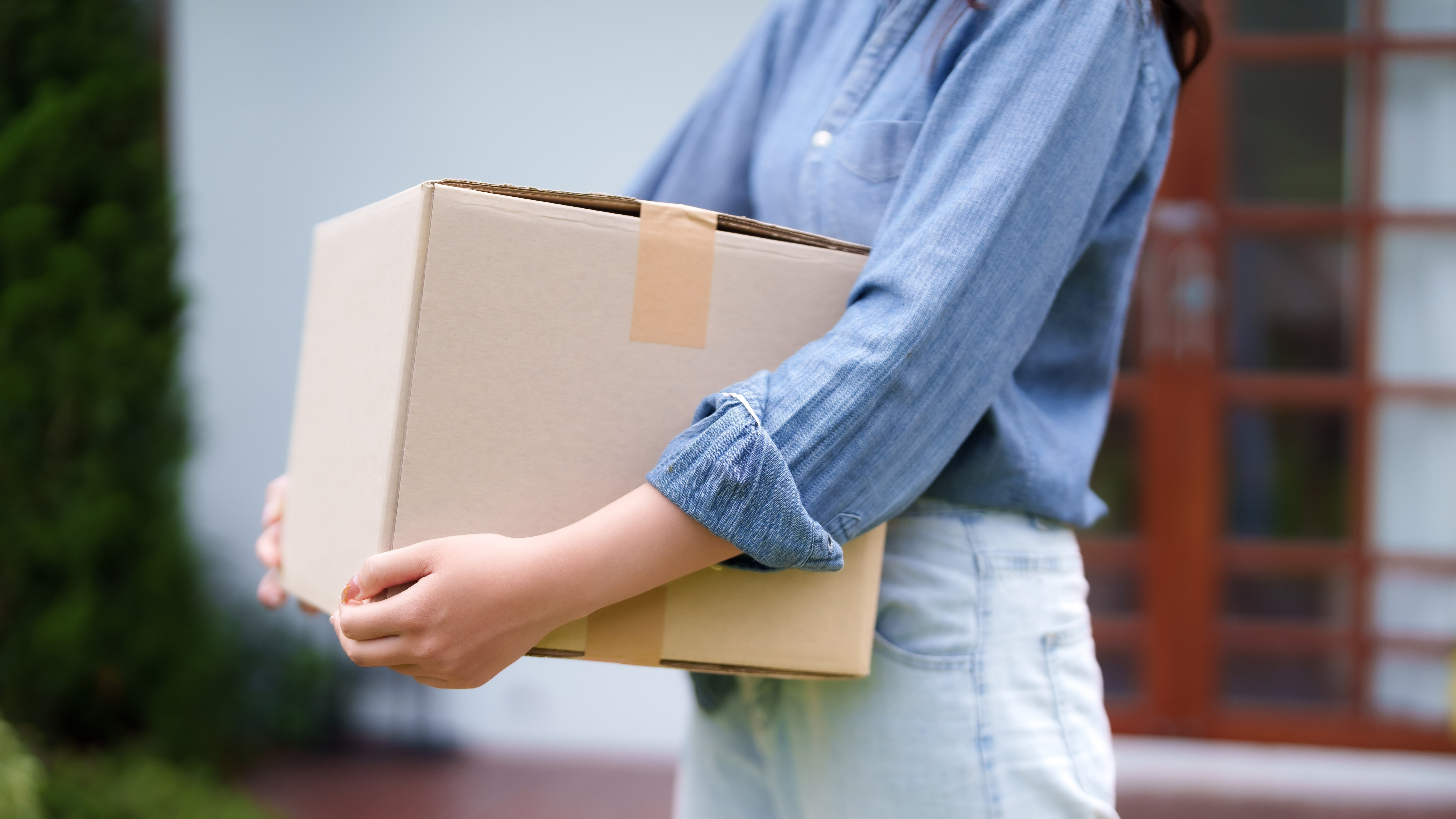Woman carrying a cardboard box