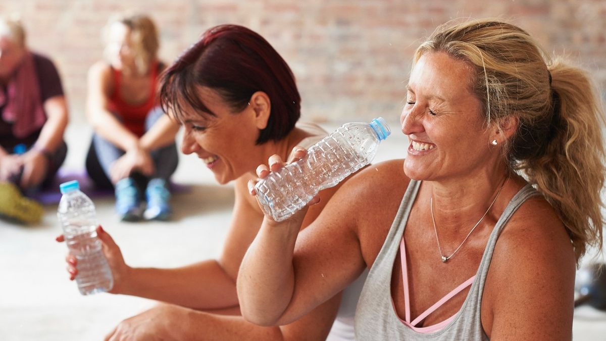 Women taking water break at fitness class