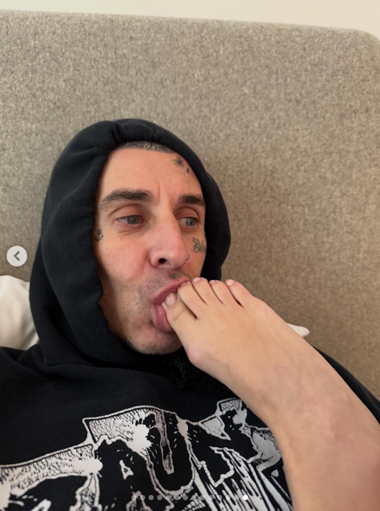 Travis Barker shared a photo to Instagram showing him with Kourtney Kardashian's toes in his mouth.