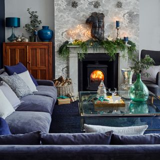 living room with fire place and blue sofa
