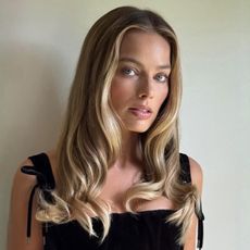 Margot Robbie wears a corset top and wide-leg trousers