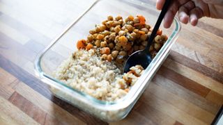 A glass tupperware box of chickpeas and white rice