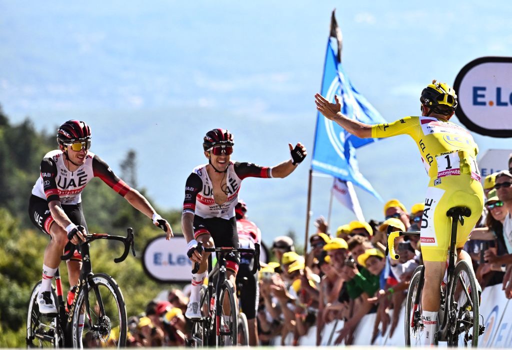 TOPSHOT UAE Team Emirates teams Slovenian rider Tadej Pogacar wearing the overall leaders yellow jersey R celebrates with his teammates after winning the 7th stage of the 109th edition of the Tour de France cycling race 1763 km between Tomblaine and La Super Planche des Belles Filles in eastern France on July 8 2022 Photo by Marco BERTORELLO AFP Photo by MARCO BERTORELLOAFP via Getty Images